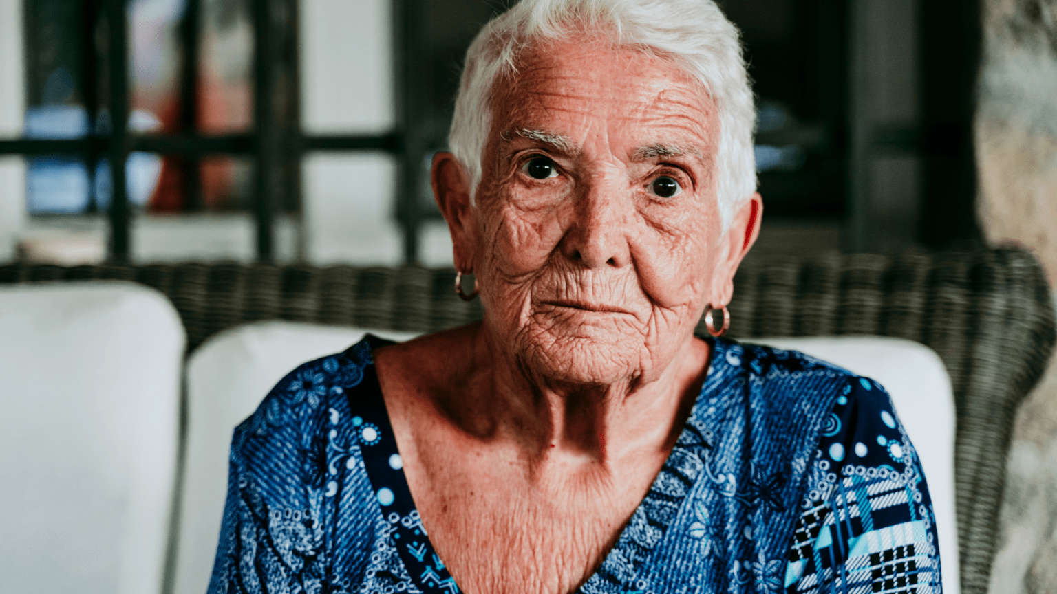 elderly woman sitting on a chair in old age home