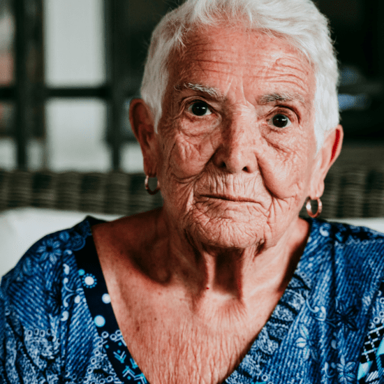 elderly woman sitting on a chair in old age home